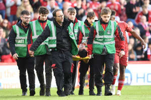 Aberdeen's Bojan Miovski is stretchered off after a tackle by St Mirren's Thierry Small