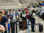 People queue to check in at Heathrow Airport on May 26, 2023 in London, England.