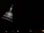 The state Capitol in Austin is seen behind parking garage lights on the evening of April 18, 2023.
