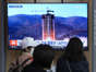 A TV screen shows a file image of North Korea's rocket launch during a news program at a railway station in Seoul.