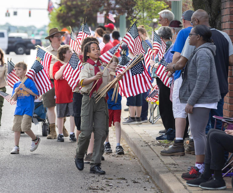 Ruben Chaney and Boy Scouts pass out flags along the route of Canton’s Memorial Day parade in this file photo from 2023.