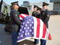 A military honor guard places a casket containing the remains of World War II airman James M. Howie at St. Louis-Lambert International Airport in St. Louis on Friday. Howie, who was killed in a crash 80 years ago, will be buried Saturday in his Illinois hometown of Chester. Photo by Bill Greenblatt/UPI