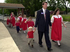 Arkansas state Rep. Jim Bob Duggar and his wife, Michelle, lead 12 of their 13 children to a polling place in Springdale, Ark., in 2002.