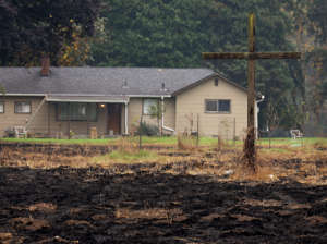 A cross in front of the home Joe and Kim Davidson remains unburned as fire moved around it Mill City after the Beachie Creek fire.