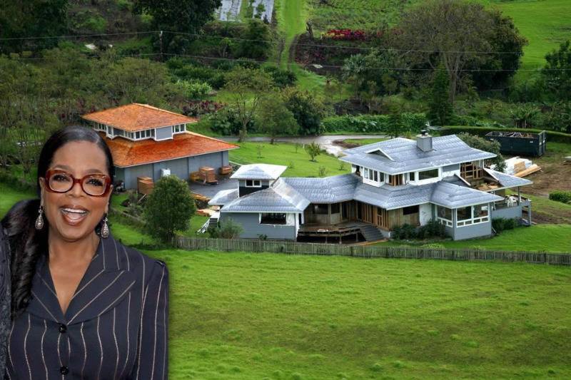 <p>Media mogul Oprah Winfrey has multiple properties in her real estate profile. One of her more famous addresses can be found in Maui, Hawaii, in a sprawling field on land that she also owns. </p> <p>The property was once a small grey ranch that the TV personality considered tearing down but instead decided to build a new structure on. The mansion to the left is now a charming modern farmhouse.</p>