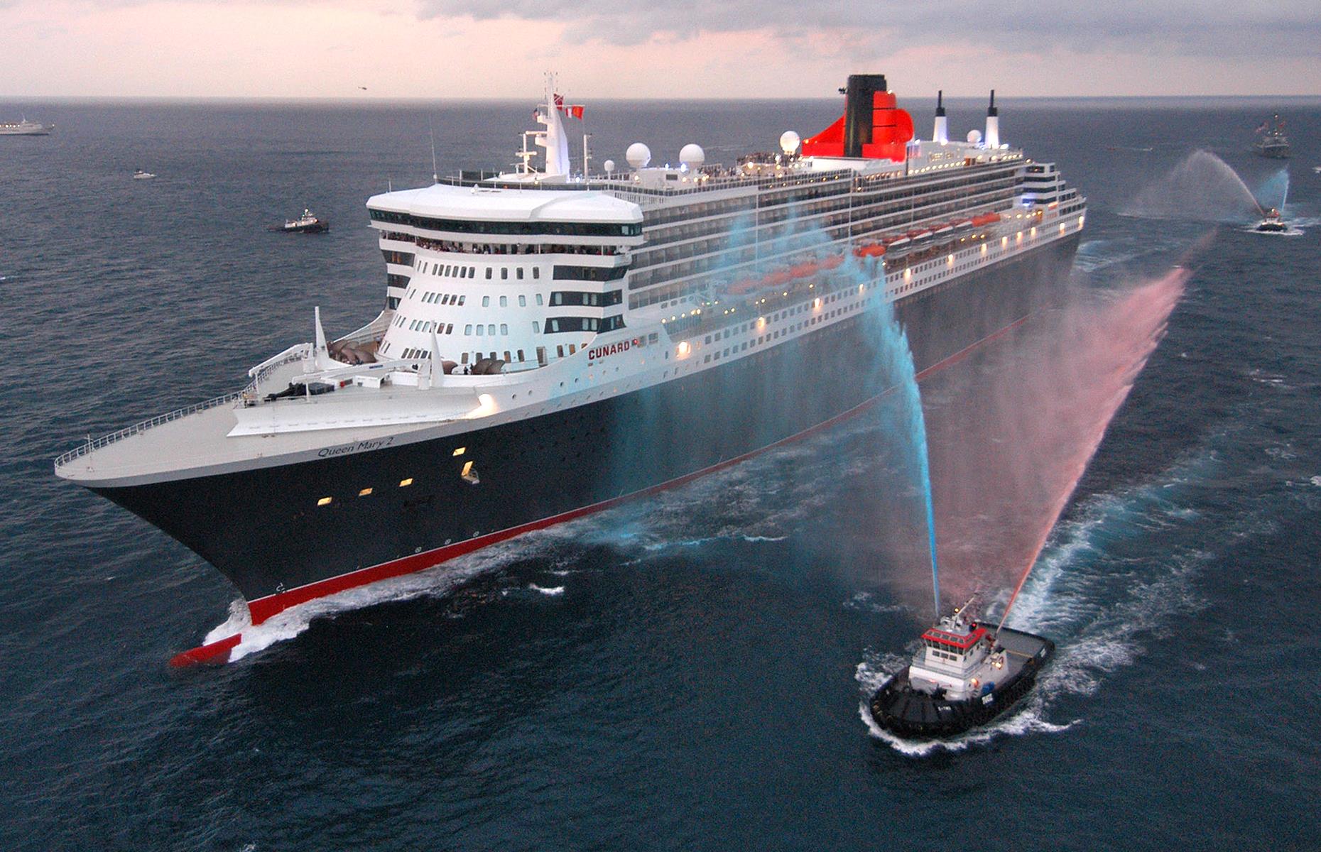 <p>The 2000s saw larger-than-life, no-expense-spared, mega cruise ships sail onto the scene. This sunset snap shows Cunard Line's Queen Mary II as she completes her first trans-Atlantic voyage in January 2004. At this time, she was the largest and most expensive cruise ship ever constructed with room for 2,200-plus passengers, a theater and even a planetarium, setting the bar for the ships of posterity. </p>