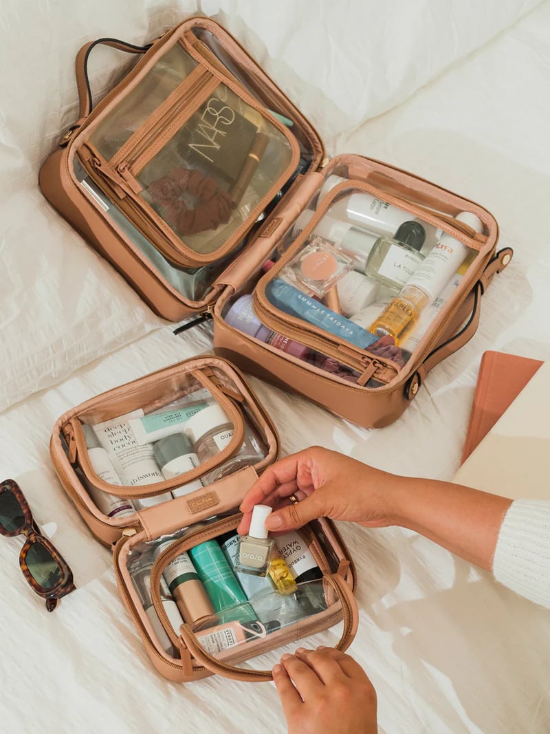 <p><a href="https://www.calpaktravel.com/products/small-clear-cosmetics-case/caramel">BUY NOW</a></p><p>$75</p><p><a href="https://www.calpaktravel.com/products/small-clear-cosmetics-case/caramel" class="ga-track"><strong>Calpak Mini Clear Cosmetics Case</strong></a> ($75)</p> <p>Calpak's Clear Cosmetics Case has gone viral for its undeniably chic look and its practical and functional design. It's a durable, water-resistant cosmetic bag that lets you see all your beauty essentials and keep them organized. The Clear Cosmetics Case has two spacious zippered compartments and two carrying handles for easy and secure transport. Plus, it has a mesh interior zippered pocket for small items as well. It is eight inches wide, four inches tall, and six inches deep. </p> <p>If you're looking for something bigger, the <a href="https://www.calpaktravel.com/products/medium-clear-cosmetics-case/aqua" class="ga-track"><strong>Medium Clear Cosmetic Case</strong></a> ($85) is 9.75 inches wide, five inches tall, 7.5 inches deep and the <a href="https://www.calpaktravel.com/products/large-clear-cosmetic-case/papaya" class="ga-track"><strong>Large Clear Cosmetic Case</strong></a> ($95) is 11.5 inches wide, 5.25 inches tall, nine inches deep.</p>