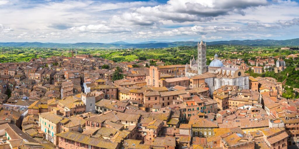 <p><em>Recommended by Teresa of T as Travel</em></p> <p>Famous mainly for the Palio, Siena is a beautiful medieval town in Tuscany that deserves at least a couple of days to be visited in Central Italy. Siena is located on a hill, surrounded by walls with some doors from which you enter the historic center.</p> <p><strong>Duomo Square</strong></p> <p>This vast square is significant for the city of Siena and its citizens. The cathedral, with white and green stripes, is the master in this square. Recommended is a visit inside the Duomo.</p> <p><strong>Piazza del Campo</strong></p> <p>Heart of Siena and one of the most beautiful squares in the world there is Piazza del Campo. Piazza del Campo means Square of Field and is called this because, in the past, it was used for markets and trades. Today it is very famous for the Palio.</p> <p><strong>Palaces</strong></p> <p>Two palaces, in particular, surround Piazza del Campo. Palazzo Pubblico and Torre dei Mangia. Palazzo Pubblico was built around 1297 as the house of Siena's government; meanwhile, Torre del Mangia was built around 1340, and it was the tallest tower in all of Italy. Today from the Tower you can have a fantastic view of all of Siena meanwhile in the Palace you can find a museum.</p> <p><strong>Baptistery of San Giovanni</strong></p> <p>Situated in Piazza San Giovanni, there is the Baptistery of San Giovanni. Built around 1320, the Baptistery is very interesting because it was the meeting point of the Renaissance artists of the time.</p> <p><strong>Visit Siena, Italy</strong></p> <p>The city of Siena has some beautiful views, streets, and doors to enter the old city all to discover; for this reason, I recommend half a day for a walk in the center.</p> <p>Like all Italy, the food is a must to try, and also, Siena has its own specialties. You must try Picci (a type of pasta), cold cuts and cheeses from Siena, and Panforte di Siena (dessert).</p>