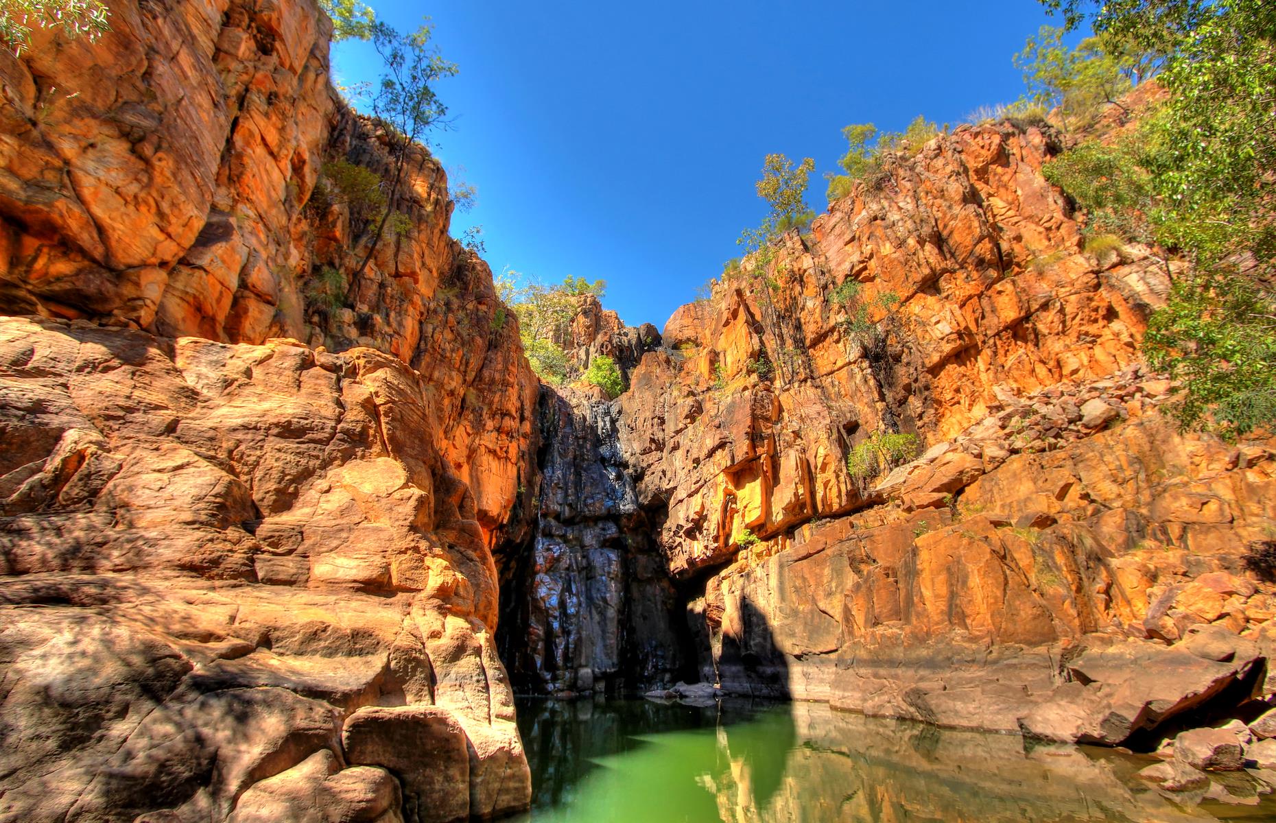 <p>Another of the Northern Territory’s colossal natural formations, the mighty Nitmiluk Gorge (sometimes known as Katherine Gorge) is a sight to behold. The vast chasm has been carved out of the sandstone cliffs by the Katherine River over thousands of years. In fact, it’s made up of 13 separate gorges and steeped in sacred places to the Jawoyn people. The best way to appreciate its size is by canoeing along the river to gaze up at the sheer cliffs and pass by its waterfalls and ancient rock art sites.</p>