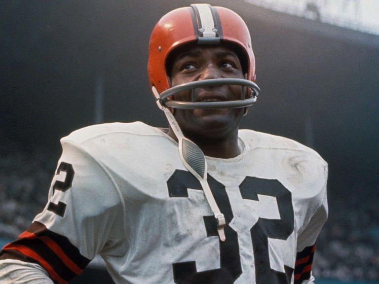 American football player, running back Jim Brown, #32 of the Cleveland Browns, stands on the field during a game.