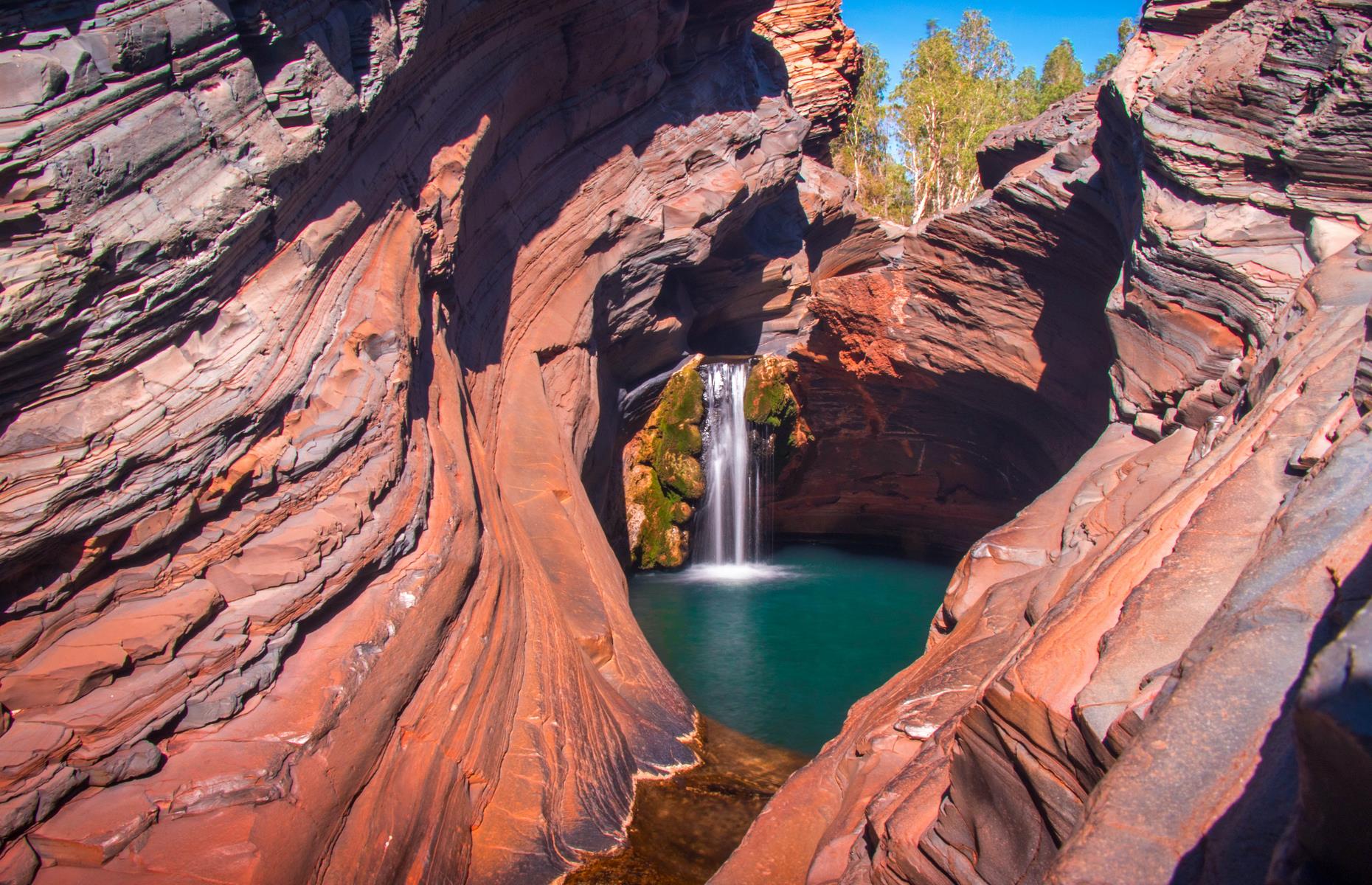 <p>Swim in spring-fed emerald pools beneath crashing waterfalls deep in the scorched depths of Western Australia’s Pilbara region. Site of some of the state's most striking scenery, Karijini National Park is known for its cavernous gorges and enticing creeks. It is home to a wide variety of birds and reptiles too, as well as red kangaroos, euros, rock-wallabies, echidnas and several bat species. Huge termite mounds also dot the landscape.</p>  <p><strong><a href="https://www.loveexploring.com/galleries/90665/24-of-australias-most-beautiful-outback-towns">Now check out Australia's most beautiful outback towns</a></strong></p>
