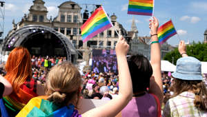 Participants of the Pride parade carry rainbow flags, on May 20, 2023 in Brussels, Belgium. The Belgian & European Pride event started with a gathering at the Pride Village at the Mont des Arts from noon, followed by a parade featuring a large rainbow flag. (