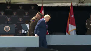 Trump walks slowly down ramp after West Point commencement speech