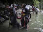 Haitian migrants wade through water as they cross the Darien Gap from Colombia to Panama in hopes of reaching the U.S. ((Ivan Valencia / Associated Press))