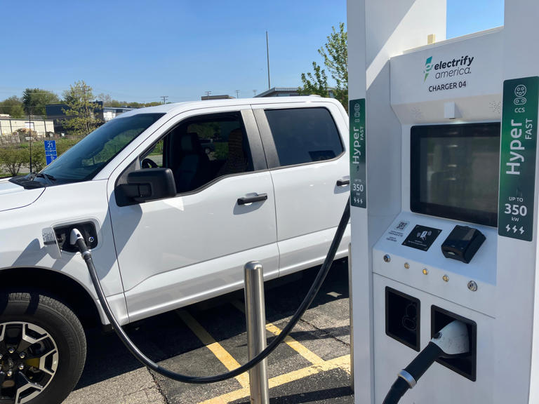 A Ford Lightning pickup truck gets fueled up at an Electrify America fast-charging station in Madison, Wisconsin.