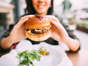 A woman is shown eating out. A new report from the CDC found that 40% of foodborne outbreaks with an identifiable cause were associated with sick workers — most often due to a virus known as norovirus. iStock