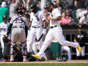 Chicago White Sox's Yoan Moncada scores the game winning run on Detroit Tigers relief pitcher Jose Cisnero's wild pitch in the 10th inning at Guaranteed Rate Field in Chicago on Saturday, June 3, 2023. Tigers catcher Eric Haase and Tim Anderson look after home plate umpire Cory Blaser who was knocked down on the play. The White Sox won 2-1.