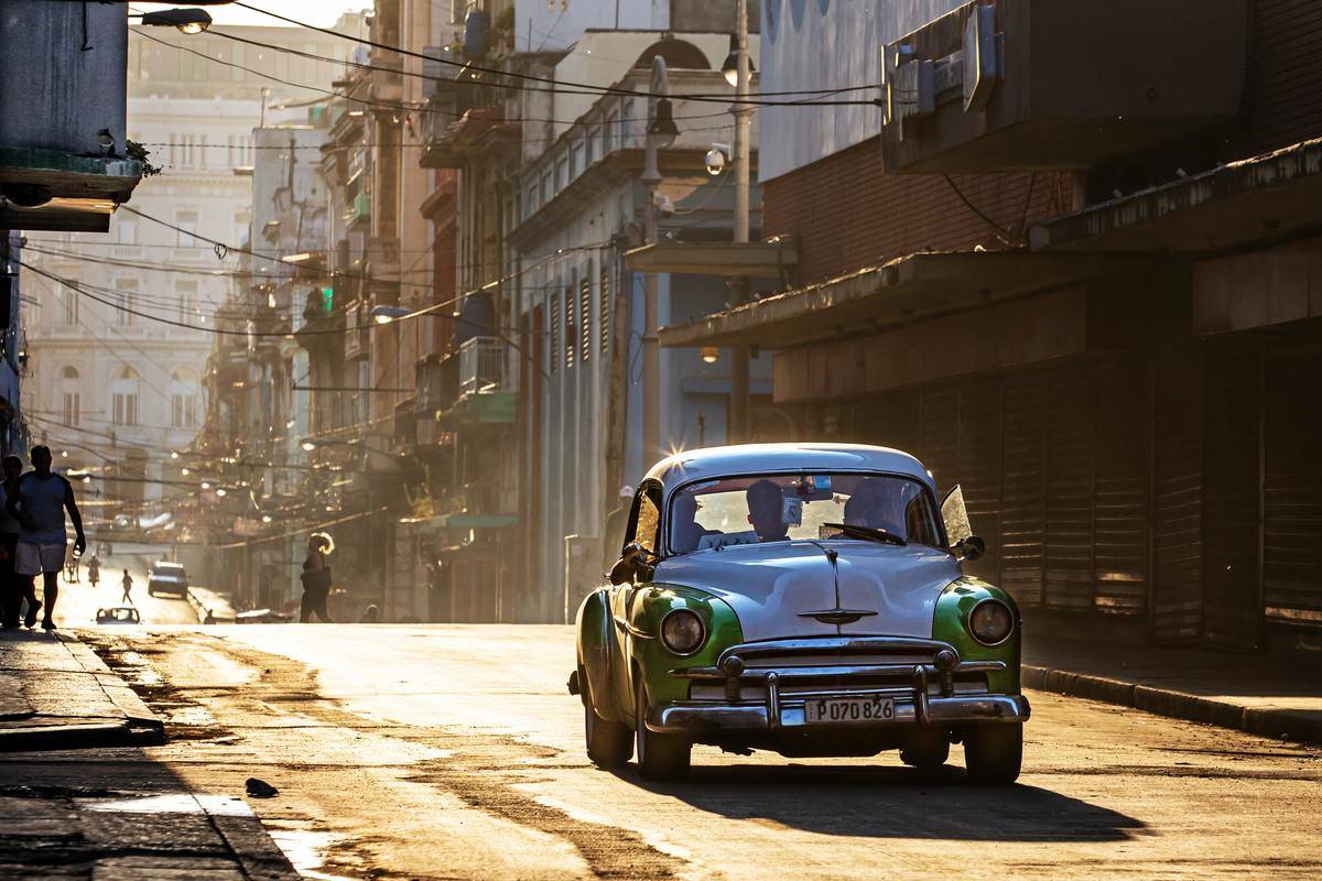 <p>Havana locals get around using a taxi system called the almendrón. If tourists want to see how to live like a Habanero, then taking one of these old-school fifties and sixties-styled cars is a right of passage.</p> <p>Keep in mind, when utilizing this transportation method, the taxi will always be filled. Drivers don't leave the curb until their car is completely filled. But the ten pesos is worth the experience.</p>