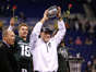 Michigan State coach Mark Dantonio holds up the Big Ten championship trophy for the fans in the crowd after defeating Ohio State 34-24 in the Big Ten championship game Saturday at Lucas Oil Stadium in Indianapolis. The Spartans will now play in the Rose Bowl on Jan. 1, 2014.