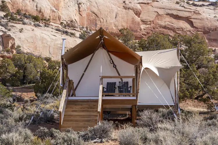 <p>The latest brainchild of the Under Canvas glamping company, <a href="https://www.ulumresorts.com/" rel="noopener noreferrer">ULUM</a> takes <a href="https://www.rd.com/list/best-camping-national-parks/" rel="noopener noreferrer">national park camping</a> to the next level. A stone's throw away from both Canyonlands and Arches National Parks, and near enough to Moab for supply runs, ULUM (pronounced ooh-loom) was built with local stone, wood and buff canvas to bring the outside in—and it's drenched in natural light. Relax in a plush tent with a king-size bed, rain showers, Aesop toiletries, wood-burning stove and private deck. If you're feeling social, you can get to know other travelers at the lounge, the dining hall or the three dipping pools. By day, stare out to 100-foot cliffs and views of Looking Glass Arch. By night, it's all about looking up into twinkling dark-sky territory.</p> <p class="listicle-page__cta-button-shop"><a class="shop-btn" href="https://www.ulumresorts.com/">Book Now</a></p>