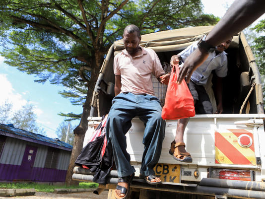 Paul Mackenzie, 50, a Kenyan cult leader accused of ordering his followers, who were members of the Good News International Church, to starve themselves to death in Shakahola forest, alights from a police pick-up truck as he arrive at the Shanzu Law Courts, in Mombasa, Kenya May 10, 2023. REUTERS/Stringer