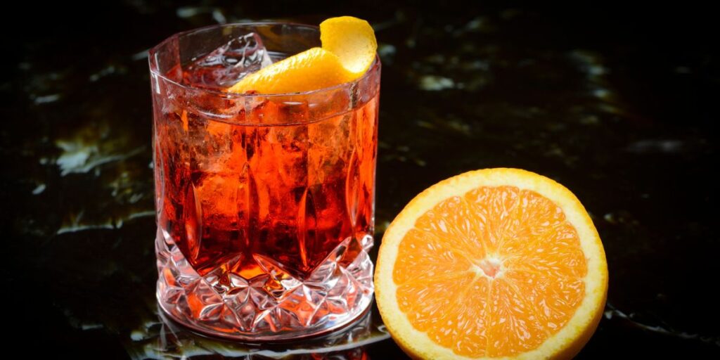 <p>A classic Italian cocktail made with equal parts gin, Campari (an Italian bitter liqueur), and sweet vermouth, garnished with an orange twist. It has a bitter and herbal flavor profile.</p>