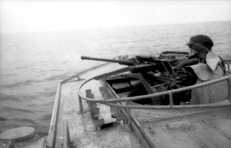 <p>The E-boat’s hull was constructed of a <a href="https://www.ww2-weapons.com/e-boat/" rel="noopener">metal frame and wood planks</a>, which reduced weight for maximized speed. The <em>S-100</em> class was 114.6 feet long, with a beam of 17.3 feet and a draught of 5.6 feet. The standard weight was 78.9 tons, with a maximum of 100 tons.</p> <p>The E-boat design featured two small rudders on either side of the main. These could be <a href="https://en.wikipedia.org/wiki/E-boat#Development" rel="noopener">angled outboard</a> up to 30 degrees, which drew in an “air pocket slightly behind the three propellers, increasing their efficiency, reducing the stern wave and keeping the boat at a nearly horizontal attitude.” This was known as the Lürssen Effect. It ultimately lifted the stern of the vessel, allowing for greater speed while reducing the stern wave produced, making the E-boat harder to see.</p> <p>The <em>S-100</em> was powered by three Daimler Benz MB 501 marine diesel engines, which <a href="https://en.wikipedia.org/wiki/E-boat#Specification" rel="noopener">produced 3,960 brake horsepower</a>. The E-boat had a range of 800 nautical miles at 30 knots and a maximum of 43.8 knots. It also carried a range of armament. Two 21-inch forward-facing torpedo tubes were located on either side of the bow, with four torpedoes stored onboard. It was also armed with three 20 mm C/30 cannons and one 37 mm Flak 42 cannon.</p>