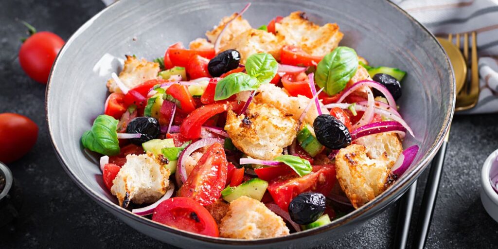<p>Tuscan bread salad made with stale bread, tomatoes, cucumbers, onions, and basil and dressed with olive oil and vinegar.</p>