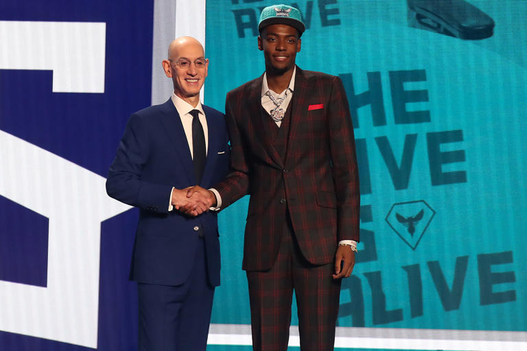 Brandon Miller (Alabama) poses with NBA commissioner Adam Silver after being selected second by the Charlotte Hornets in the first round of the 2023 NBA Draft.