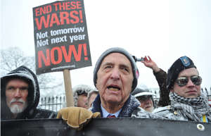 Daniel Ellsberg, center, former military analyst who released the "Pentagon Papers" in 1971, speaks to the media during an anti-war protest Dec. 16, 2010, in front of the White House in Washington, D.C.