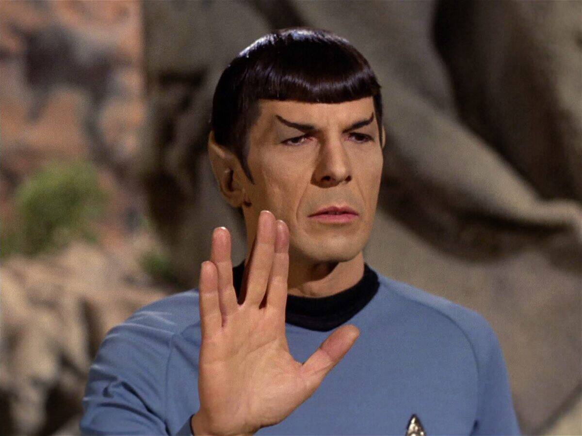 <p>The origin of Spock's iconic salute can be traced to Leonard Nimoy's creative inspiration. Drawing from his Jewish heritage, Nimoy crafted the distinctive gesture by adapting the hand sign used in a sacred Hebrew blessing. </p> <p>The open hand, with fingers separated in a "V" shape, became synonymous with Vulcan culture and a beloved symbol for <i>Star Trek</i> fans worldwide.</p>