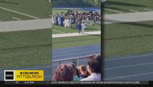 South Park High School student helps classmate during graduation ceremony