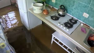 Nova Kakhovka resident takes stock of his flooded home after dam breach