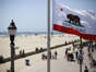 The California flag waves in the breeze near the Huntington Beach Pier in 2020. ((Raul Roa / Los Angeles Times))