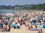 People enjoying the warm weather at Bournemouth beach in Dorset.