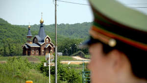 A file photo showing a Chinese border guard stands watch at a border crossing with Russia at the Chinese border town of Suifenhe, northeastern Heilongjiang province