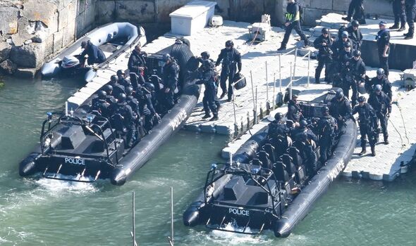 armed police unit docks at uk port before 305ft barge arrives to house up to 500 migrants