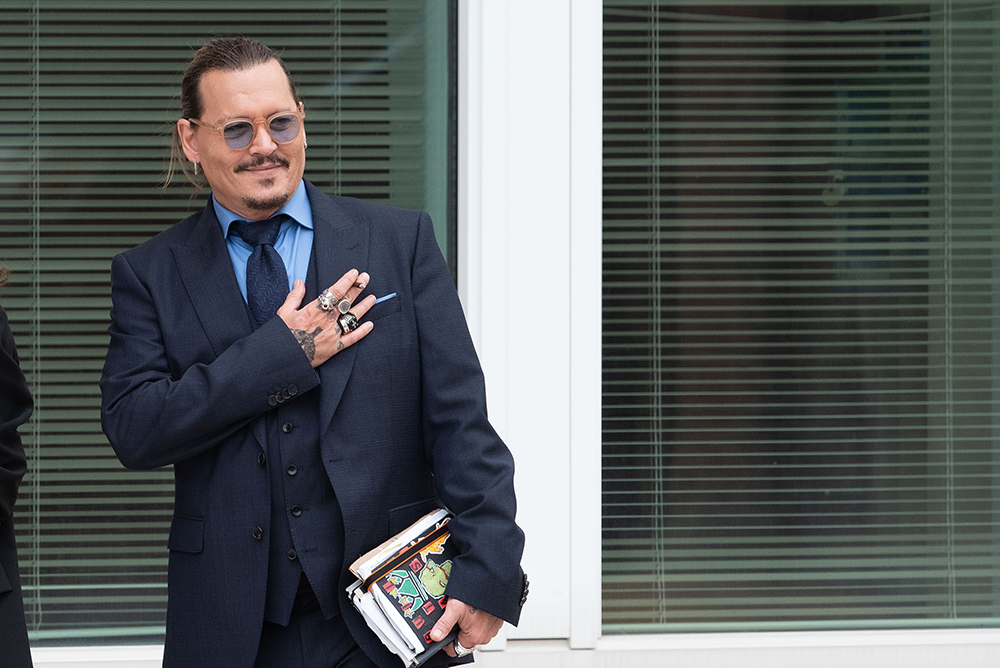 <p>Johnny Depp gestures to fans during a recess in his civil trial with Amber Heard, at the Fairfax County Courthouse, in Fairfax, Virginia on May 27, 2022. Johnny won a $15million settlement in the defamation case, with his ex wife.</p>