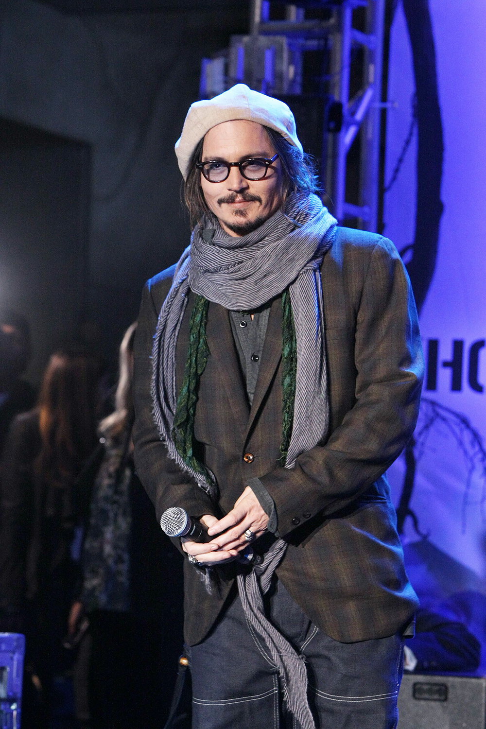 <p>Johnny Depp bundles up a fan event celebrating ‘Alice In Wonderland’ on Feb. 19, 2010. He looked vagabond-chic in a hat, plenty of scarves, and layers of jackets and cardigans.</p>