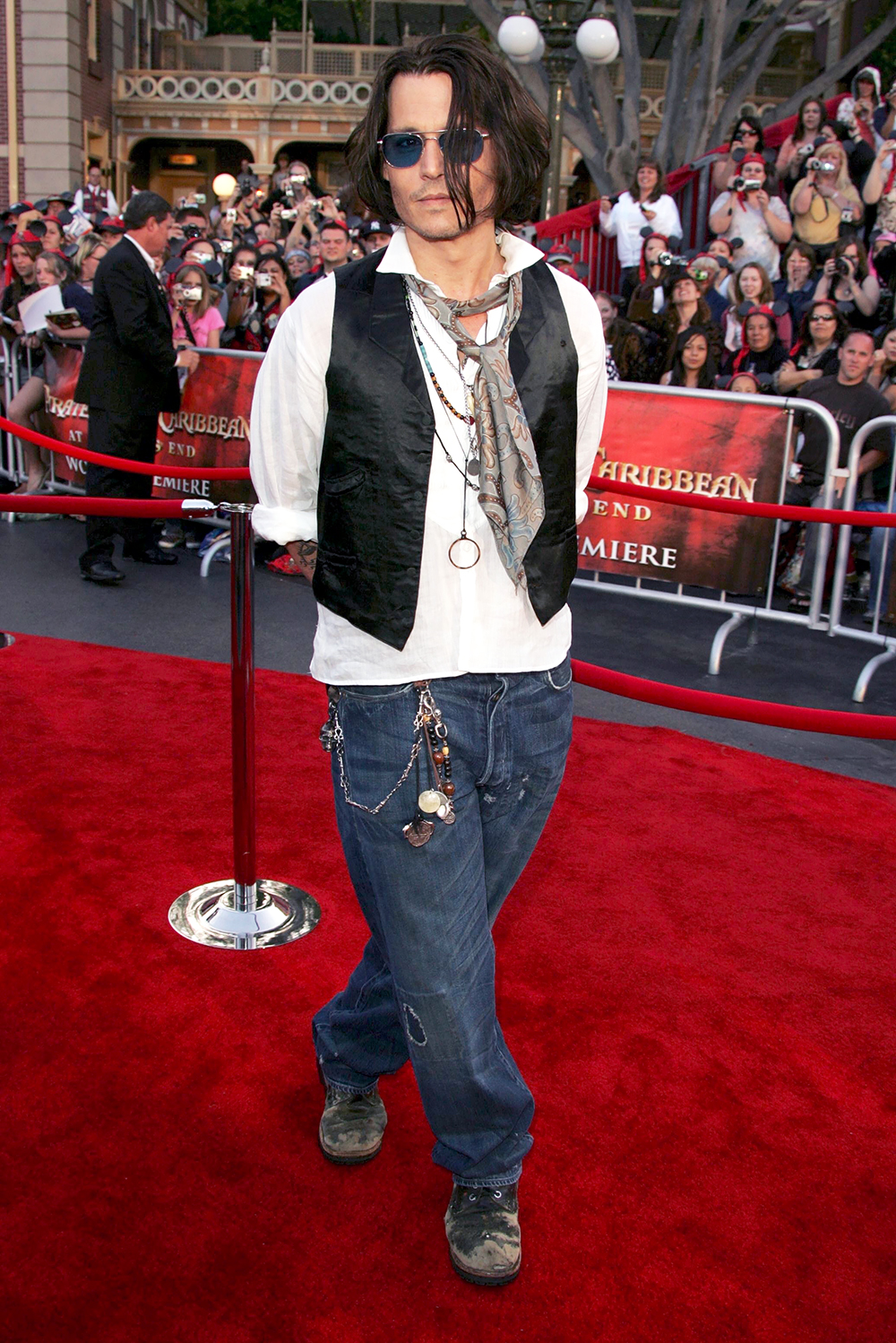 <p>Johnny Depp would return to his role of Jack Sparrow four more times. Here, looks rocker chic at the premiere of ‘Pirates of the Caribbean: At World’s End’ at Disneyland on May 19, 2017. Looking very bohemian, he wore baggy jeans, a vest, a scarf, and plenty of beads.</p>
