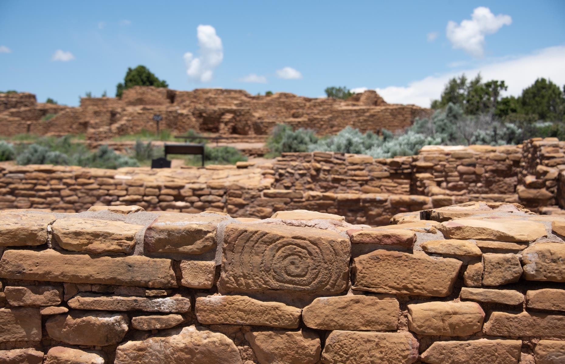 <p>This spiral on the south side of a dwelling called Pipe Shrine House is another good example of a petroglyph at Mesa Verde. Spirals are found in many Ancestral Puebloan sites and are interpreted by experts as depictions of migrations. In a Mesa Verde trail guide, Puebloan expert Jim Enote explains: "Migration has always been part of the human experience as we adapt to changing situations. I also think a spiral is a metaphor for finding our center and truth."</p>