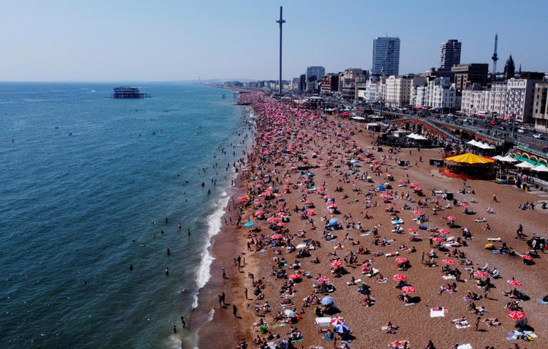 Beaches including Brighton have been packed on what is the joint hottest day of the year (Picture: REUTERS)