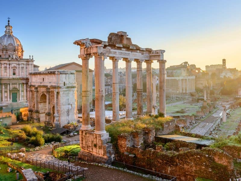 The Roman Forum in Rome, a sprawling archaeological site filled with ancient ruins, columns, and fragments, offering a glimpse into the vibrant public life and political center of ancient Rome.