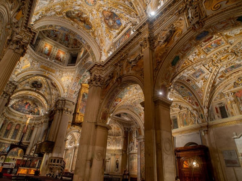Look up and immersed in a celestial panorama, with celestial figures, angels, and ornate architectural details seamlessly blending together, creating a celestial masterpiece that adds to the overall grandeur and spiritual ambiance of the basilica.