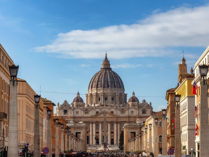A photo of St. Peter's Basilica, a breathtaking architectural marvel in Vatican City, featuring a stunning dome, intricate details, and a serene atmosphere sorround with locals and tourist.