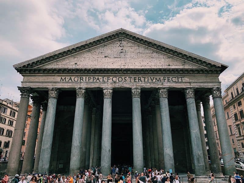 The Pantheon is a true architectural masterpiece in the heart of Rome. Its iconic dome, supported by massive columns, stands tall against the sky. With enthusiastic tourists capturing their memories with cameras and smartphones. 