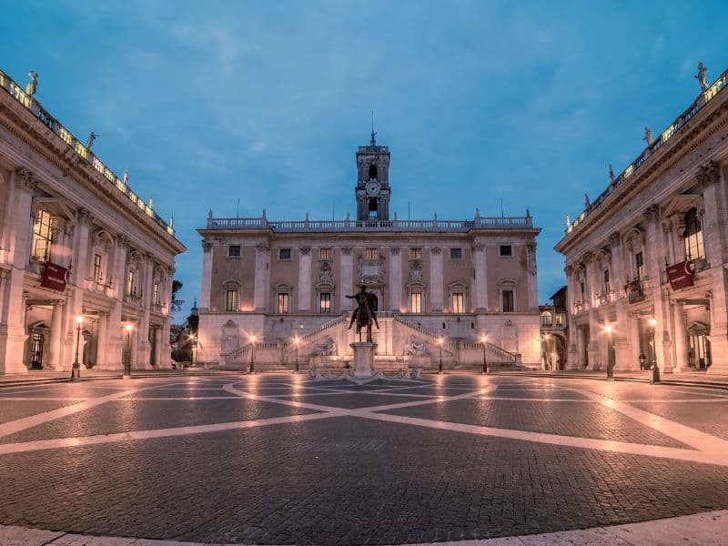 The enchanting allure of the Capitoline Museums at night, where art and history come alive in a whole new light. As darkness falls, the magnificent palaces that house the museums are beautifully illuminated, casting a warm glow on the surrounding square.