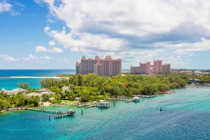 Sunny day in one of the idyllic beaches of Paradise Island, Nassau, Bahamas. Caribbean and tropical beach scene at Nassau with white sand coastline and deep blue sea, Bahamas. Island of the lighthouse tower. Caribbean sea at summer with amazing cloudscape.