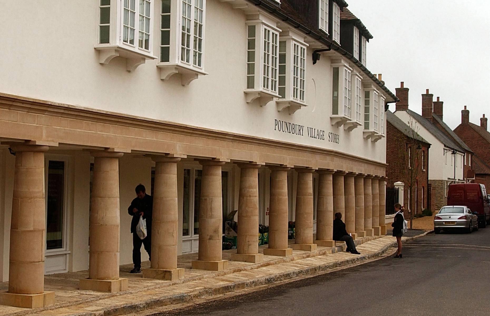 <p>The market hall on Pummery Square, which is the hub of Phase One of Poundbury’s construction, would not be out of place in a medieval village. Designed by <a href="https://www.architectmagazine.com/design/behind-the-facade-of-prince-charless-poundbury_o">architect John Simpson</a>, it was completed in 2001 and is used for public and theatrical events. Other buildings on the square include the Village stores, The Poet Laureate Pub (named in honour of Ted Hughes) and other small shops and cafés. </p>