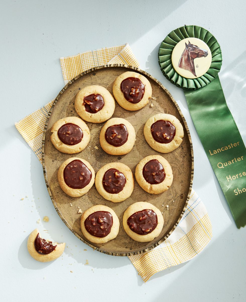<p>We will bet on this theme for an early May birthday any day! These cookies will have guests delighted to gallop into the second half of their lives. Prize ribbons are a fun and high-impact way to decorate for a Derby-themed party. </p><p><a href="https://www.countryliving.com/food-drinks/a32042556/caramel-chocolate-walnut-thumbprint-cookies/"><strong>Get the recipe for Caramel-Chocolate-Walnut Thumbprint Cookies</strong></a><strong>.</strong></p>